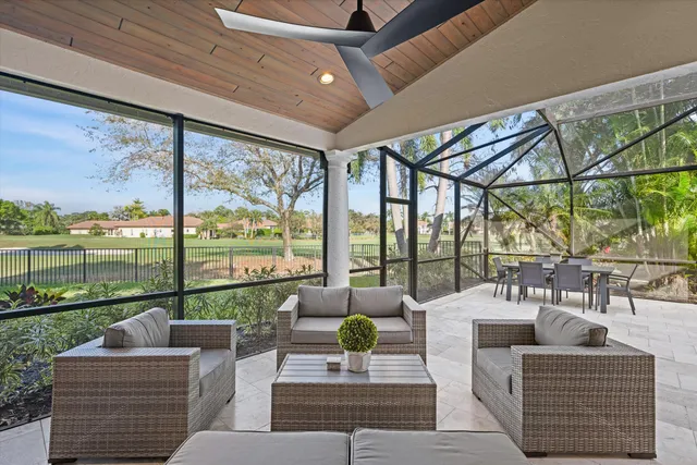 a living room with furniture and a floor to ceiling window