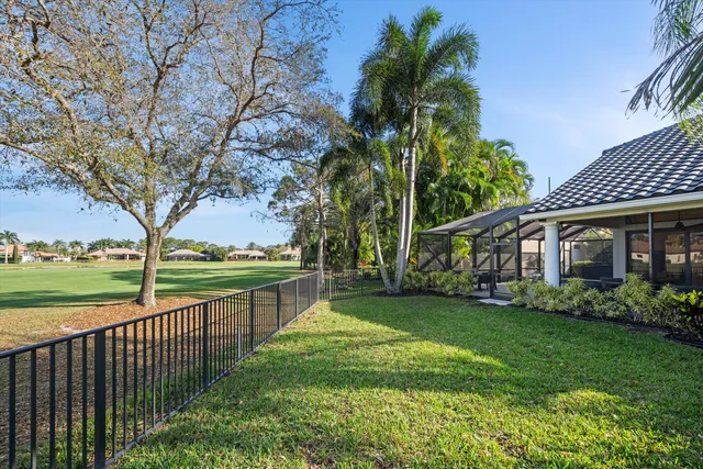 a view of a house with a yard and potted plants