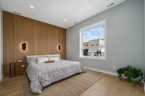 a bedroom with a large bed and a window