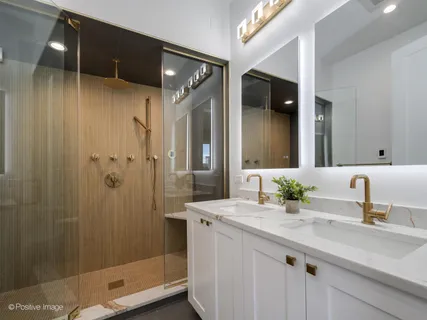 a bathroom with a shower sink and mirror