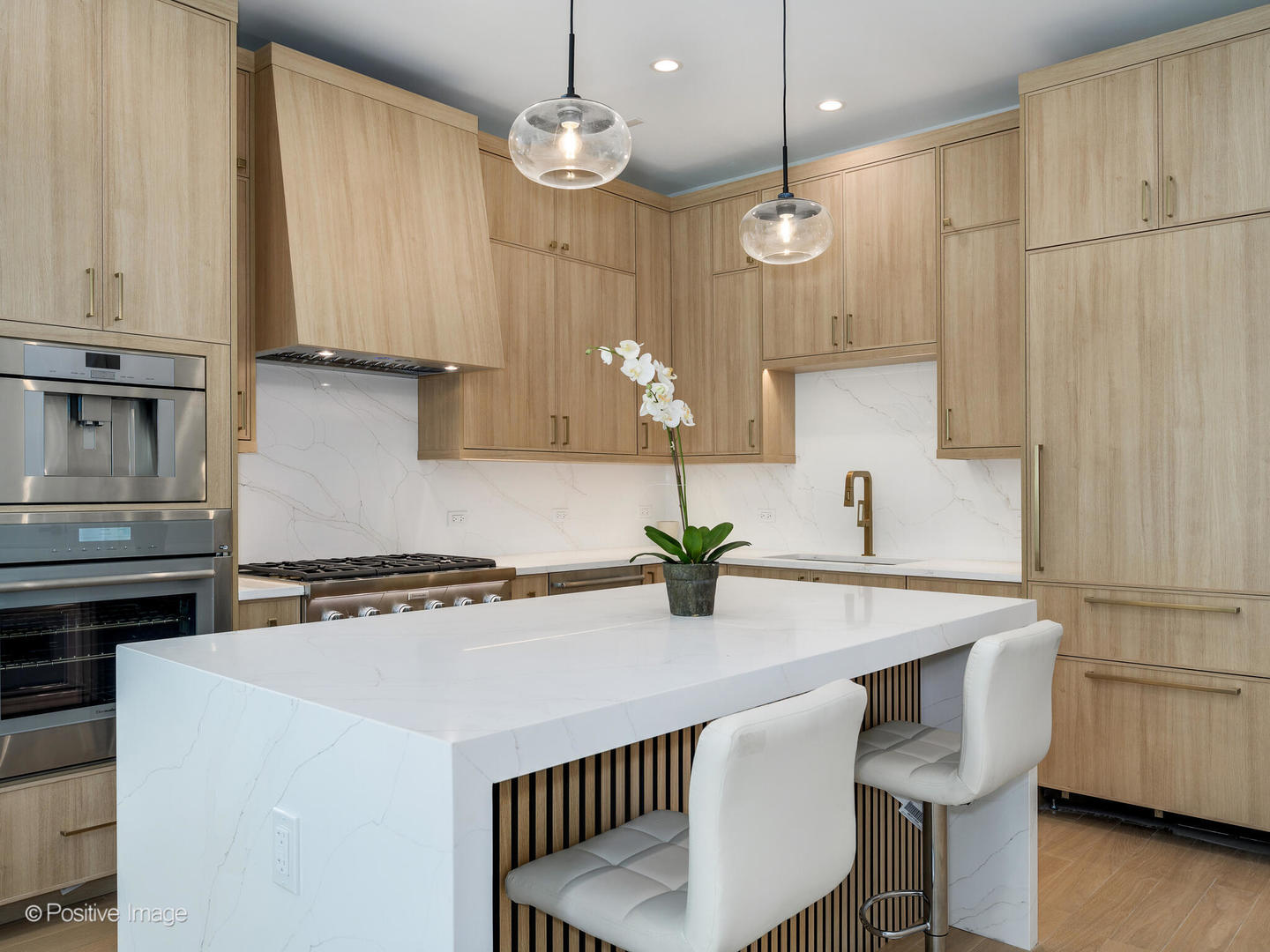 867 North Marshfield Avenue, Unit 3 Chicago, IL 60622 - Photo 6 of 26 a kitchen with kitchen island granite countertop a sink a stove a refrigerator and white cabinets