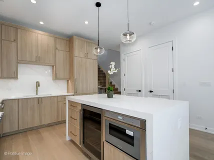 a kitchen with a stove a sink and a refrigerator