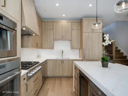 a kitchen with granite countertop a sink a stove and refrigerator