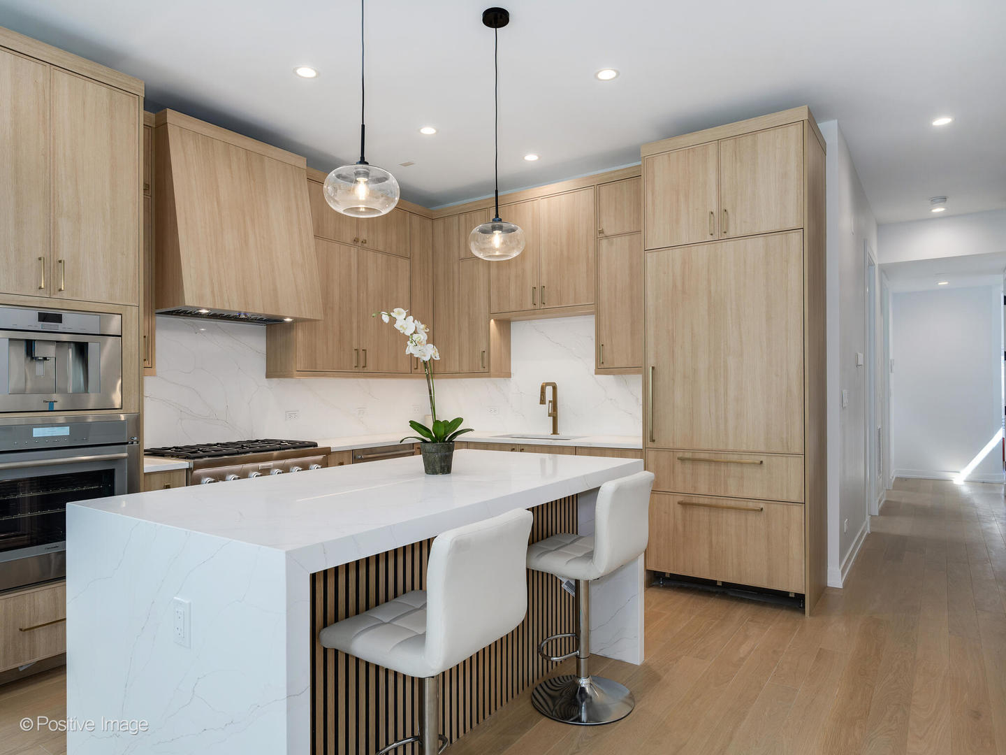 867 North Marshfield Avenue, Unit 3 Chicago, IL 60622 - Photo 9 of 26 a kitchen with stainless steel appliances granite countertop a sink a stove a refrigerator and island with wooden floor