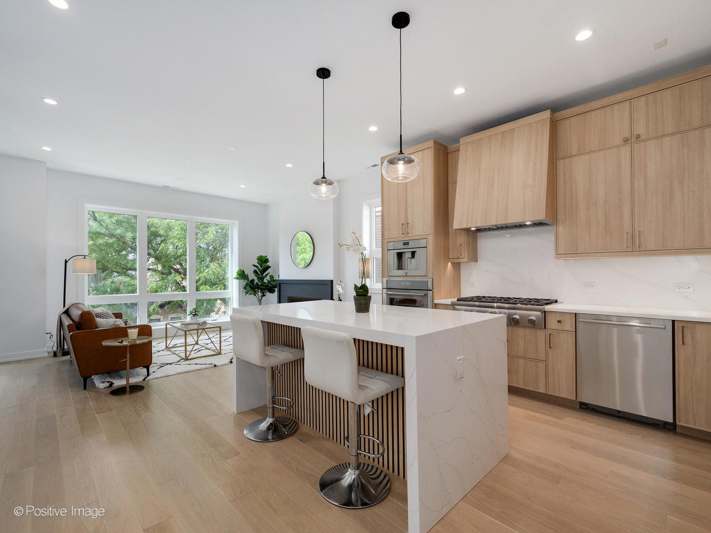 867 North Marshfield Avenue, Unit 3 Chicago, IL 60622 - Photo 10 of 26 a kitchen with kitchen island granite countertop a stove a sink a oven a dining table chairs and window