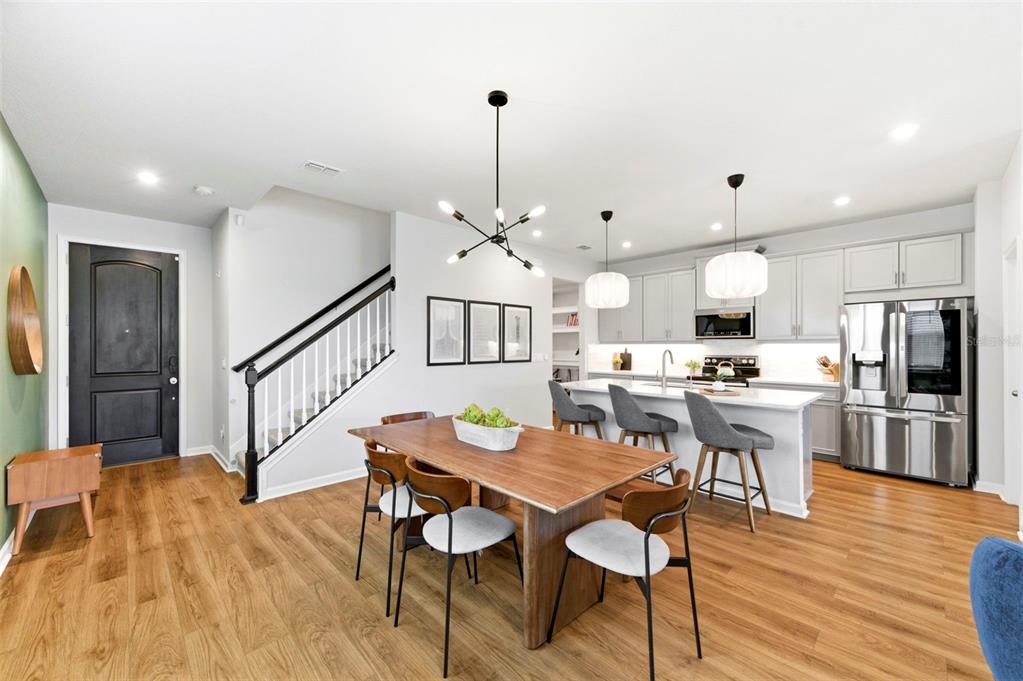 4327 Cloud Hopper Way Lutz, FL 33559 - Photo 12 of 75 a view of a dining room with furniture a chandelier and wooden floor