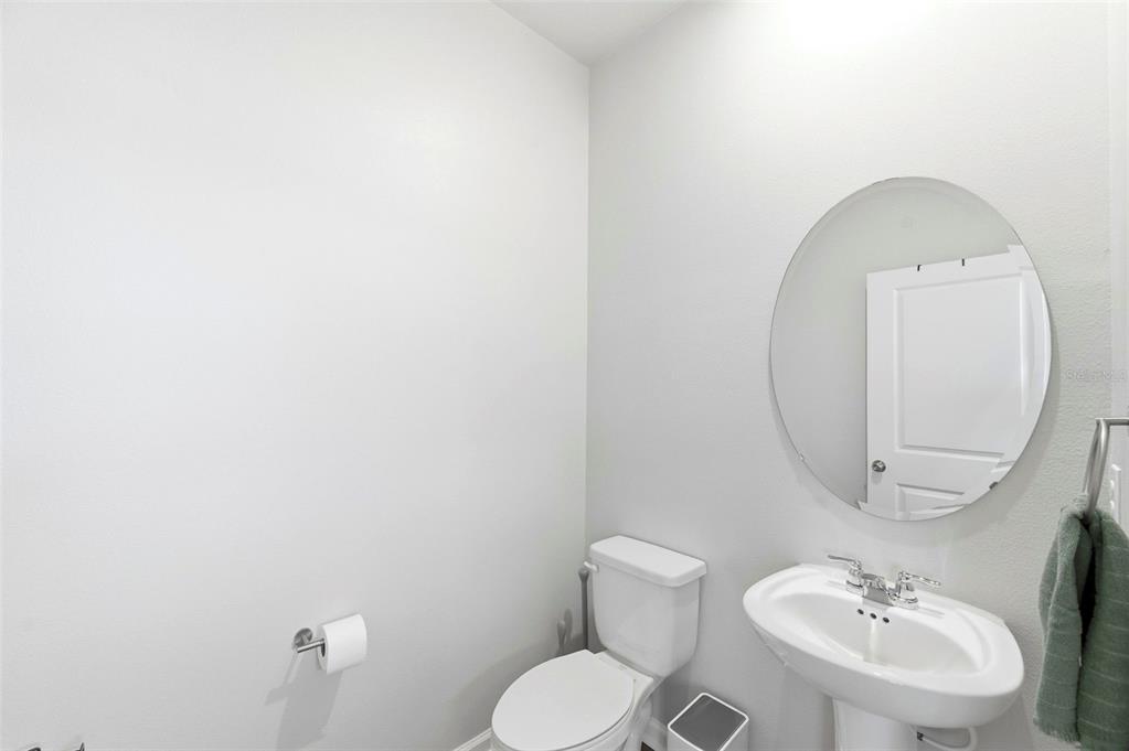 4327 Cloud Hopper Way Lutz, FL 33559 - Photo 22 of 75 a bathroom with a toilet sink and mirror