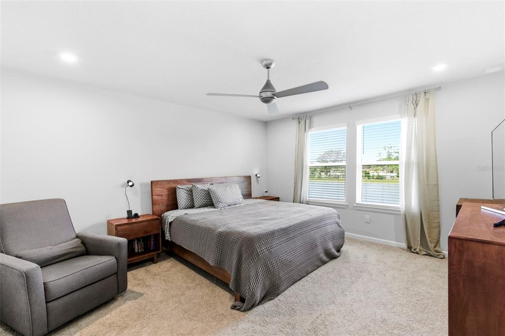4327 Cloud Hopper Way Lutz, FL 33559 - Photo 28 of 75 a bedroom with a bed couch and window