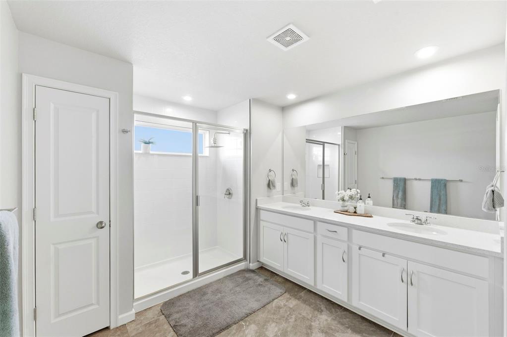 4327 Cloud Hopper Way Lutz, FL 33559 - Photo 32 of 75 a spacious bathroom with a double vanity sink mirror and shower