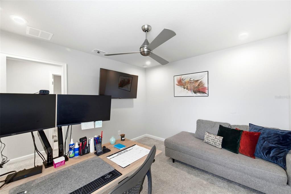 4327 Cloud Hopper Way Lutz, FL 33559 - Photo 40 of 75 a living room with furniture and a flat screen tv