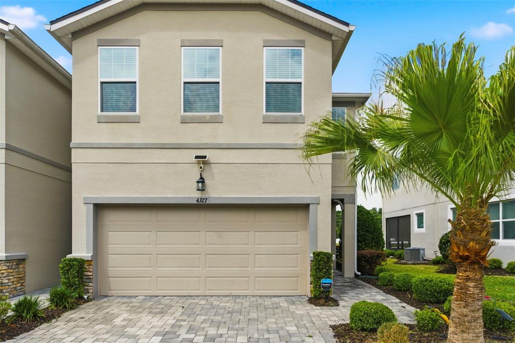 4327 Cloud Hopper Way Lutz, FL 33559 - Photo 4 of 75 a front view of a house with a garage