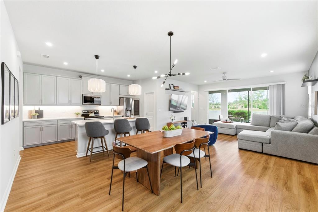 4327 Cloud Hopper Way Lutz, FL 33559 - Photo 7 of 75 a view of a dining room and livingroom with furniture wooden floor a rug and a chandelier