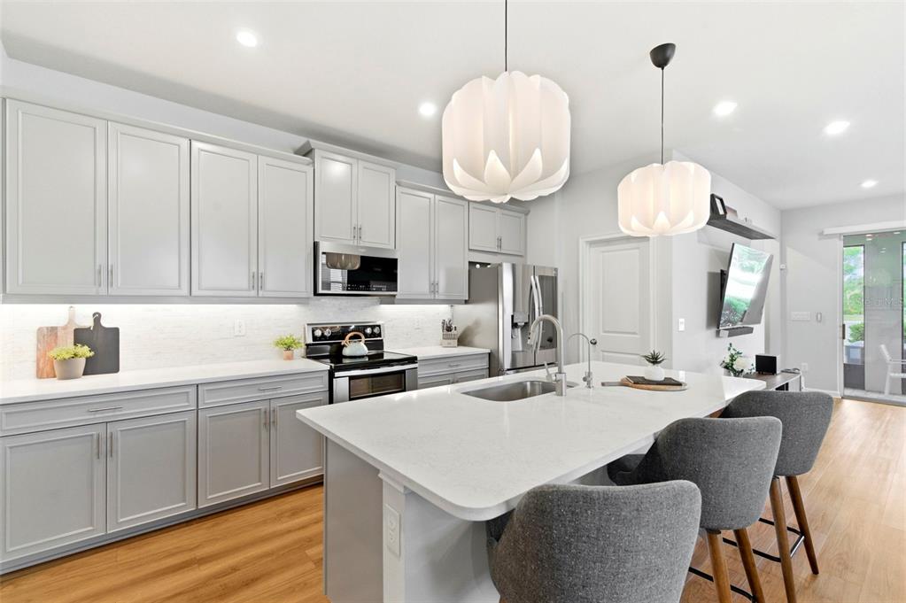 4327 Cloud Hopper Way Lutz, FL 33559 - Photo 9 of 75 a kitchen with cabinets a sink and stove