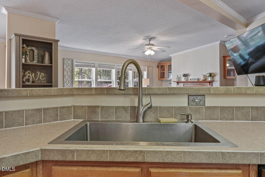 251 Ridge View Drive Cameron, NC 28326 - Photo 18 of 44 a view of a kitchen sink with wooden cabinet