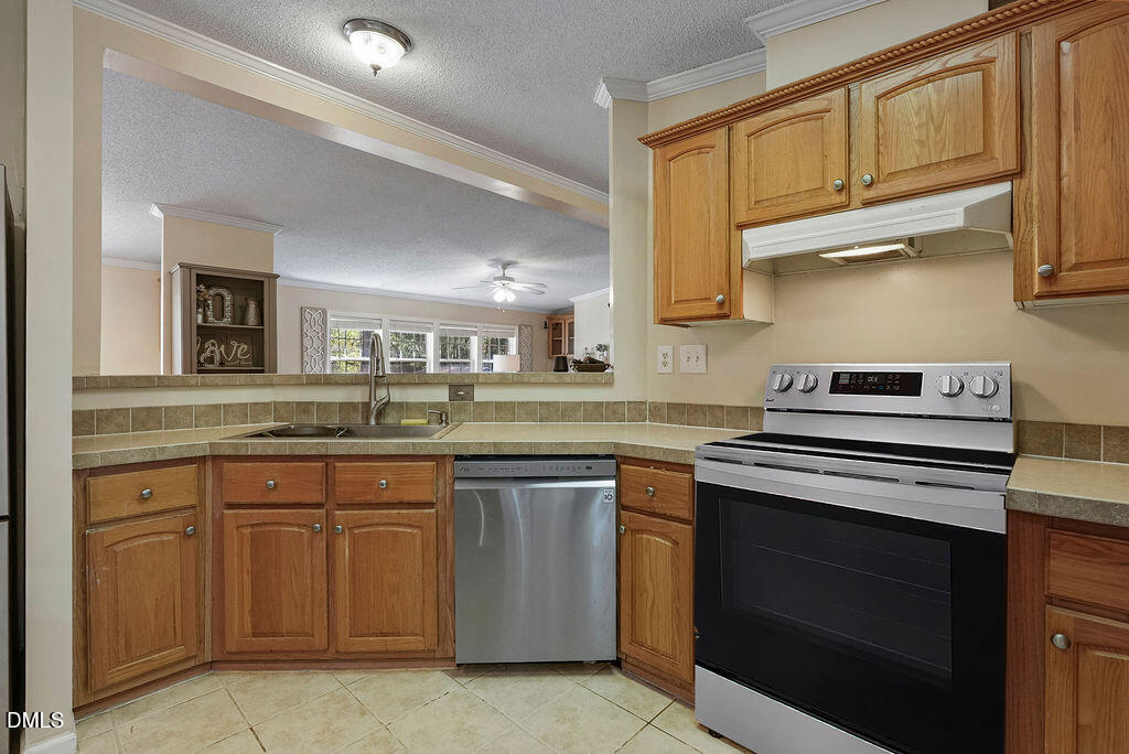 251 Ridge View Drive Cameron, NC 28326 - Photo 20 of 44 a kitchen with stainless steel appliances granite countertop a stove and a sink