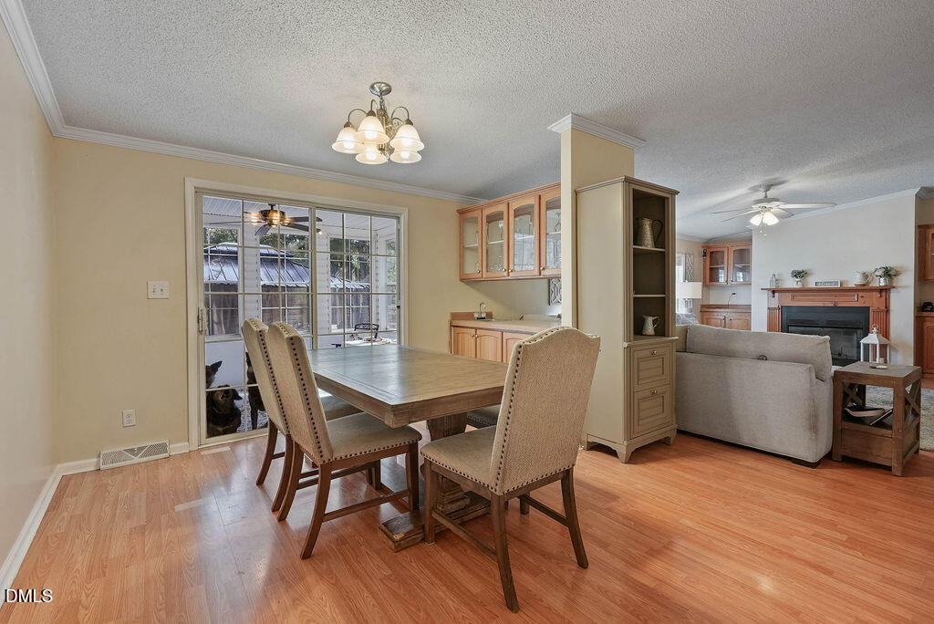 251 Ridge View Drive Cameron, NC 28326 - Photo 24 of 44 a view of a dining room with furniture a chandelier and wooden floor