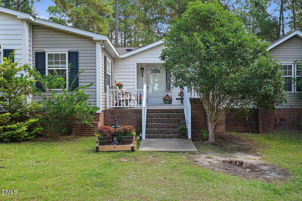 251 Ridge View Drive Cameron, NC 28326 - Photo 4 of 44 a view of a house with a yard plants and large tree