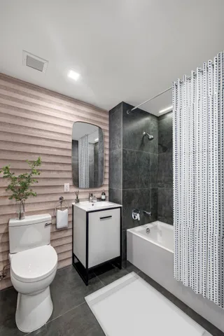 a bathroom with a toilet a sink and bathtub