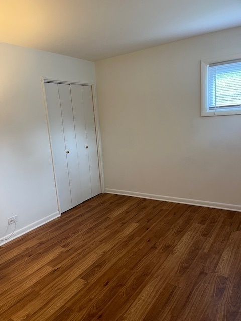 3027 Wilshire Avenue Markham, IL 60428 - Photo 13 of 16 a view of an empty room with wooden floor and a window