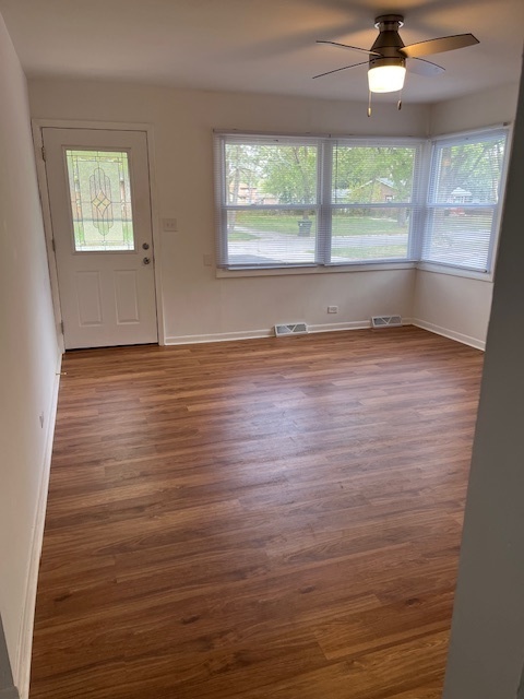 3027 Wilshire Avenue Markham, IL 60428 - Photo 6 of 16 an empty room with wooden floor and windows