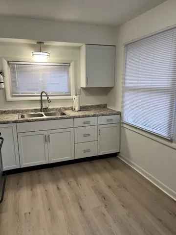 a kitchen with sink and cabinets