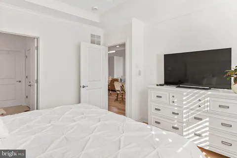 a bedroom with a bed and flat screen tv