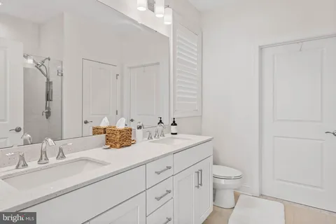 a bathroom with a sink a toilet and a mirror