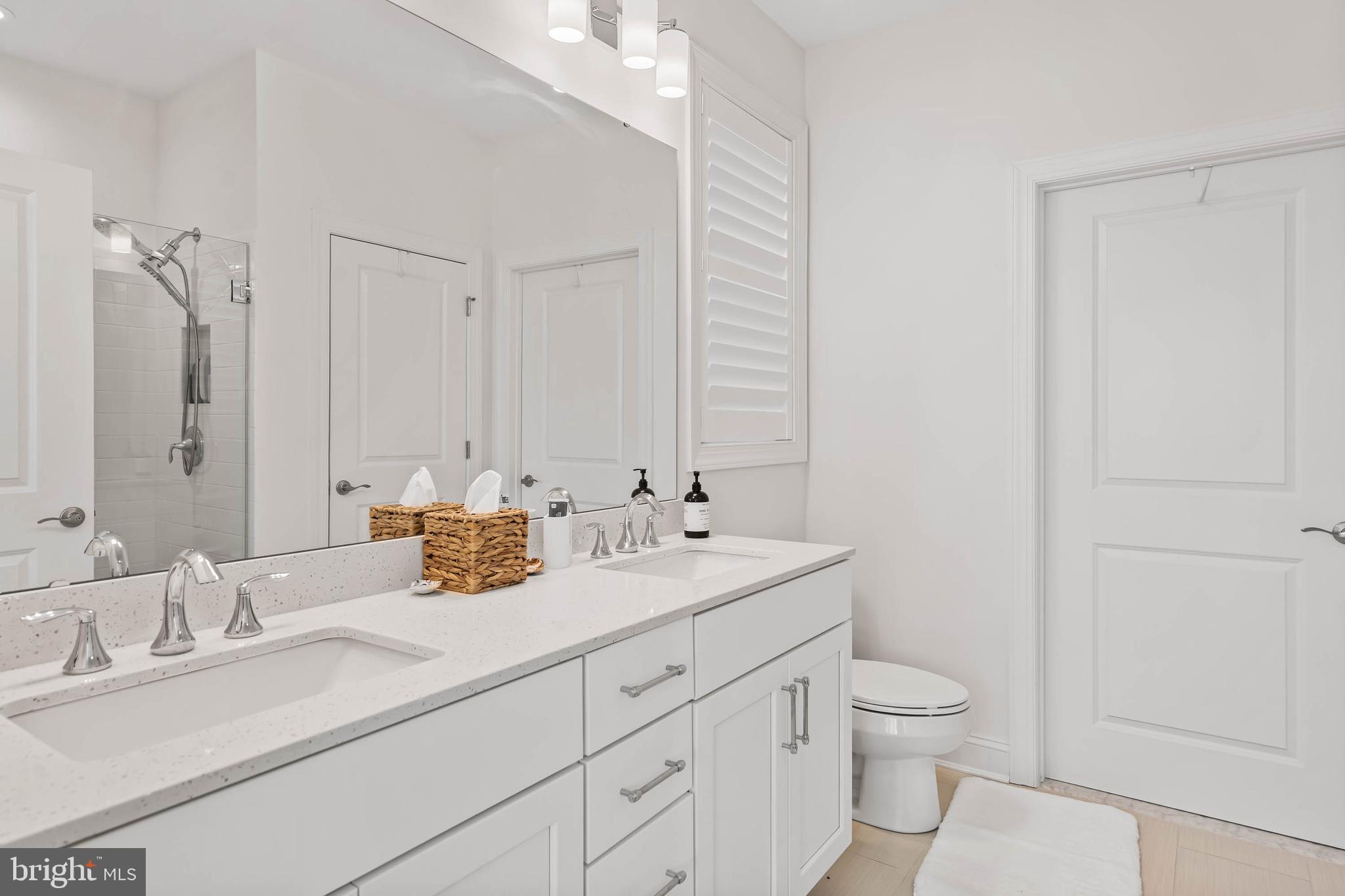 30468 Madeira Lane Ocean View, DE 19970 - Photo 13 of 56 a bathroom with a sink a toilet and a mirror