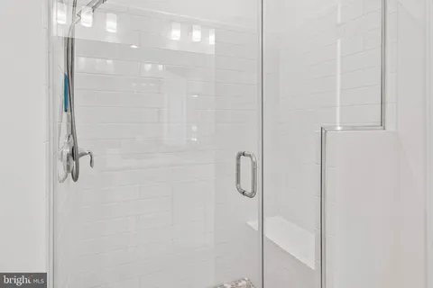 a bathroom with a glass shower door