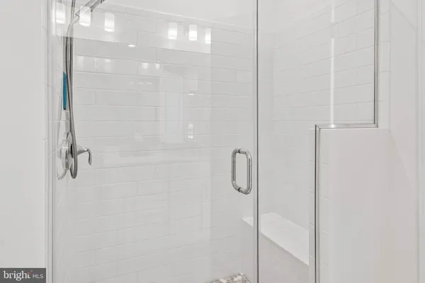 a bathroom with a glass shower door