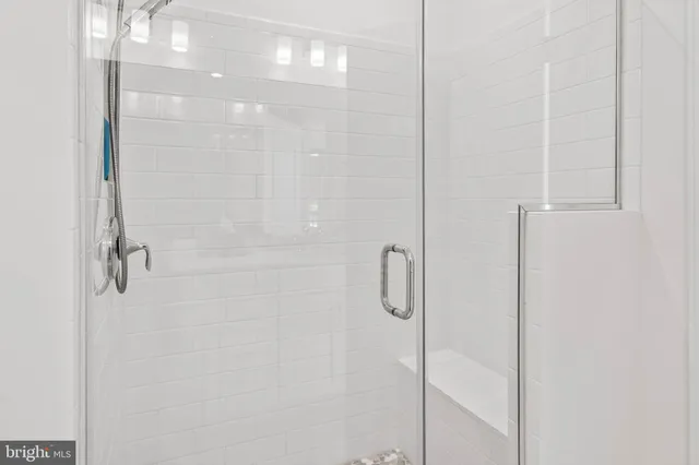 a bathroom with a glass shower door
