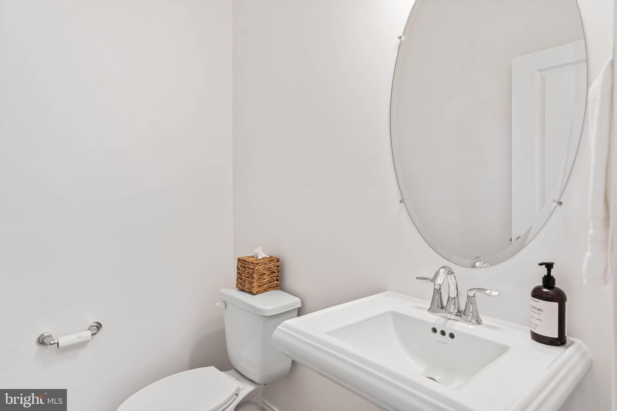 30468 Madeira Lane Ocean View, DE 19970 - Photo 17 of 56 a bathroom with a sink mirror and toilet