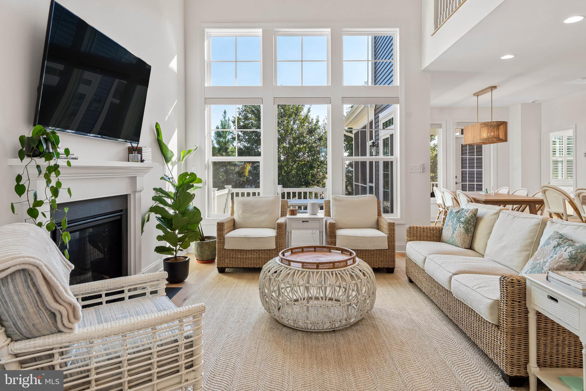 30468 Madeira Lane Ocean View, DE 19970 - Photo 2 of 56 a living room with furniture a flat screen tv and a fireplace