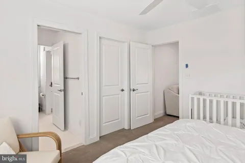 a bedroom with a bed and a ceiling fan