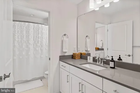 a living room with furniture and a ceiling fan