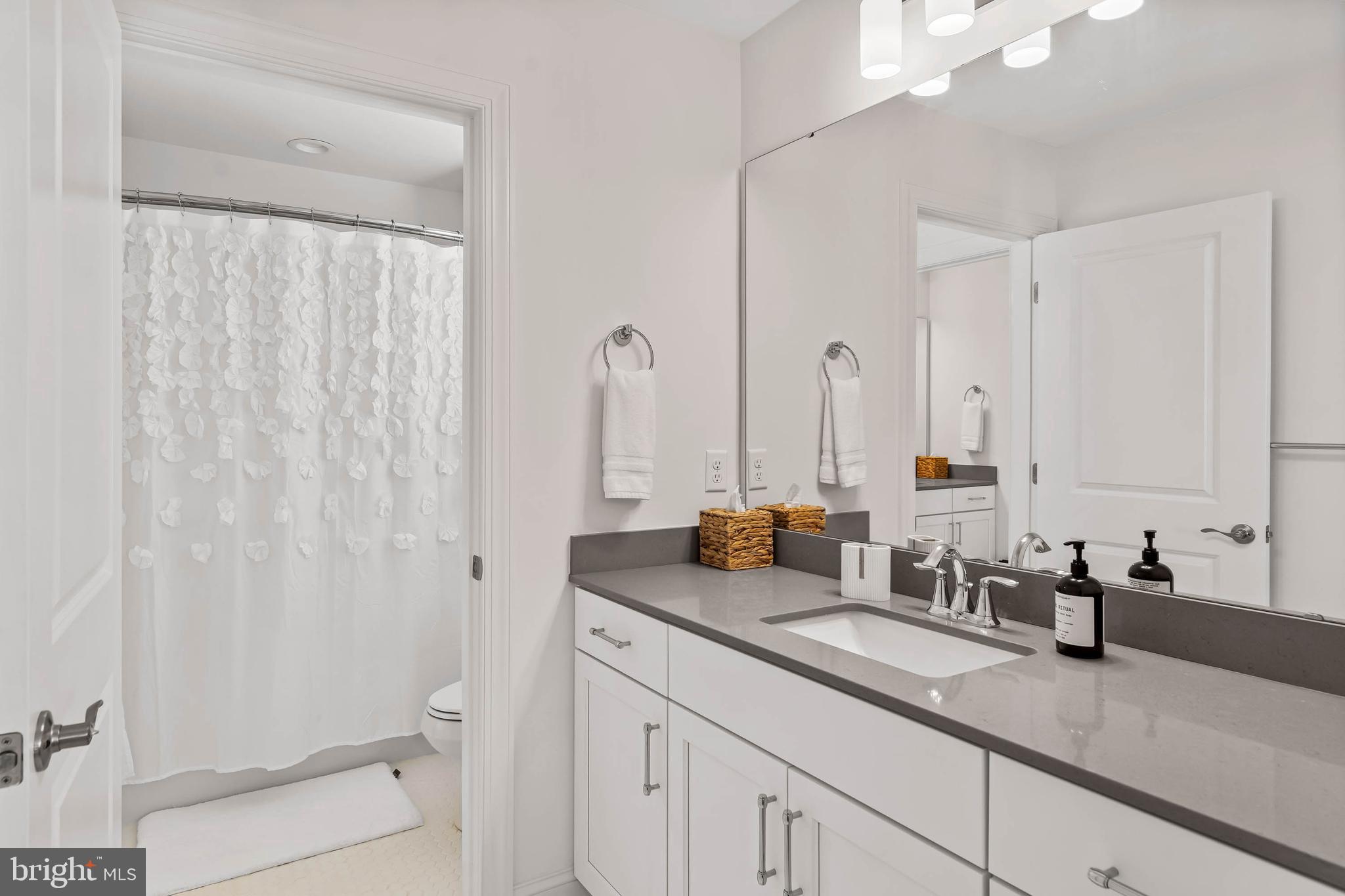 30468 Madeira Lane Ocean View, DE 19970 - Photo 29 of 56 a bathroom with a granite countertop sink and a mirror