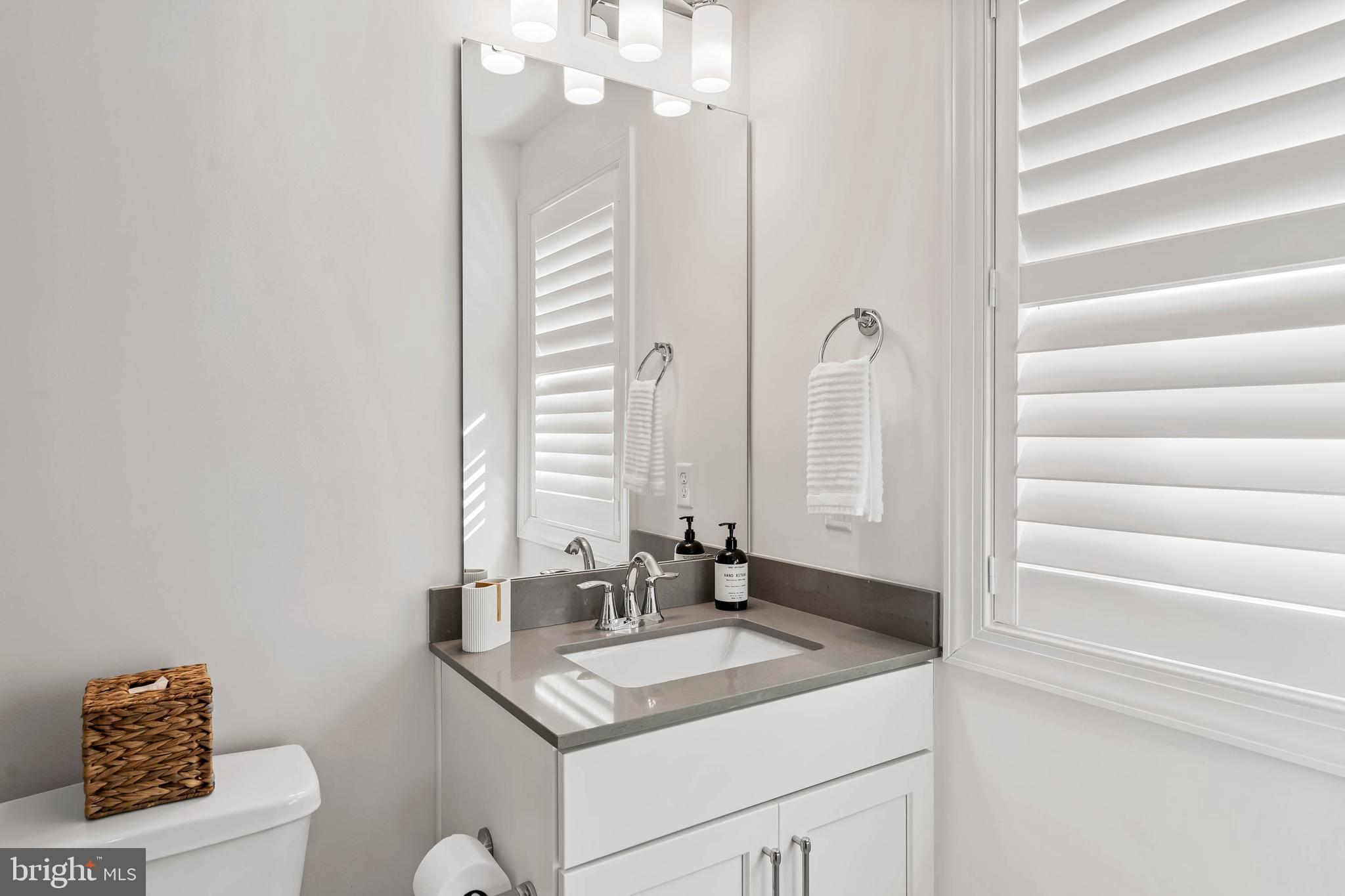 30468 Madeira Lane Ocean View, DE 19970 - Photo 32 of 56 a bathroom with a sink and a mirror