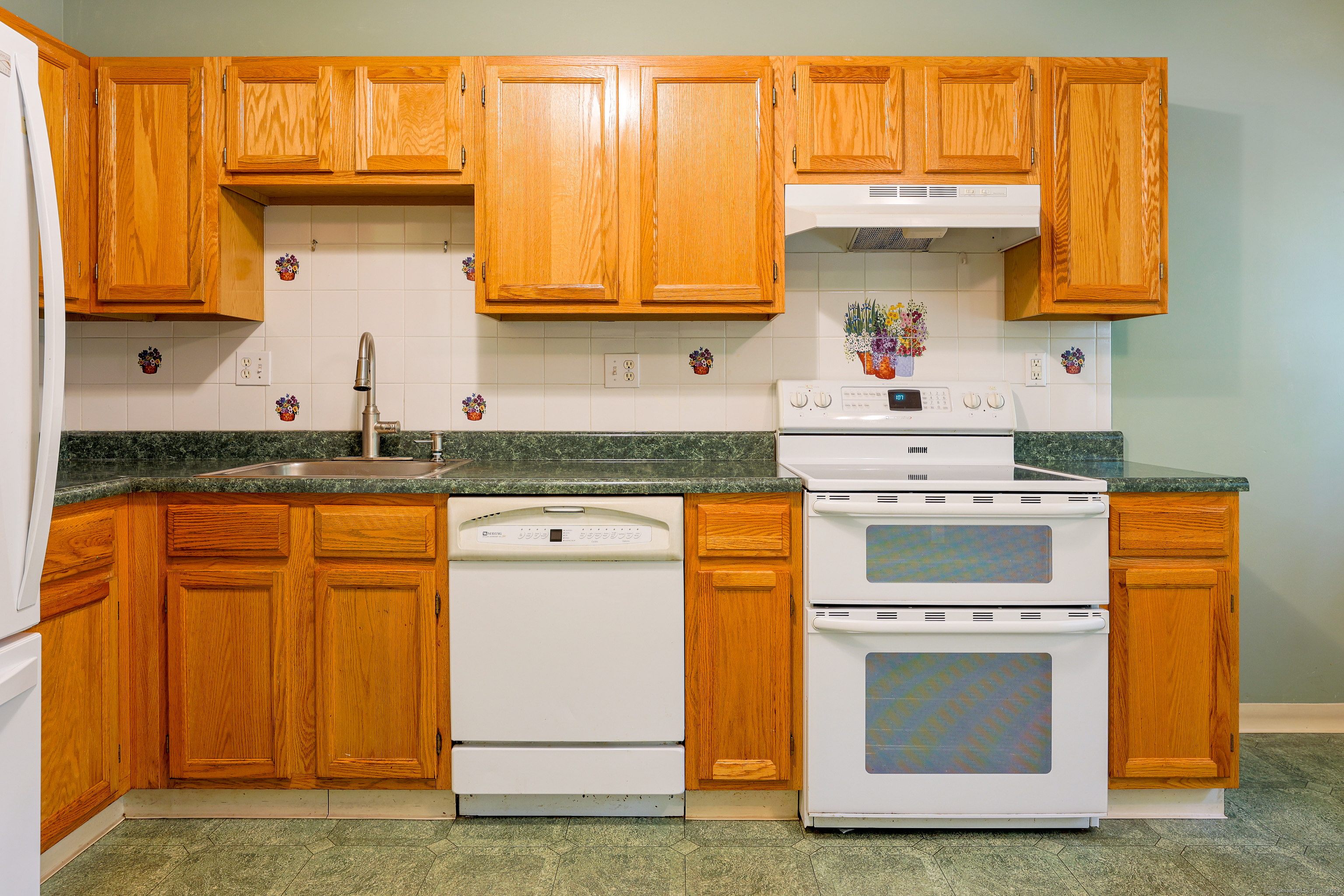 150 Forest Road, Unit 6 Milford, CT 06461 - Photo 11 of 26 a kitchen with granite countertop white cabinets and white appliances