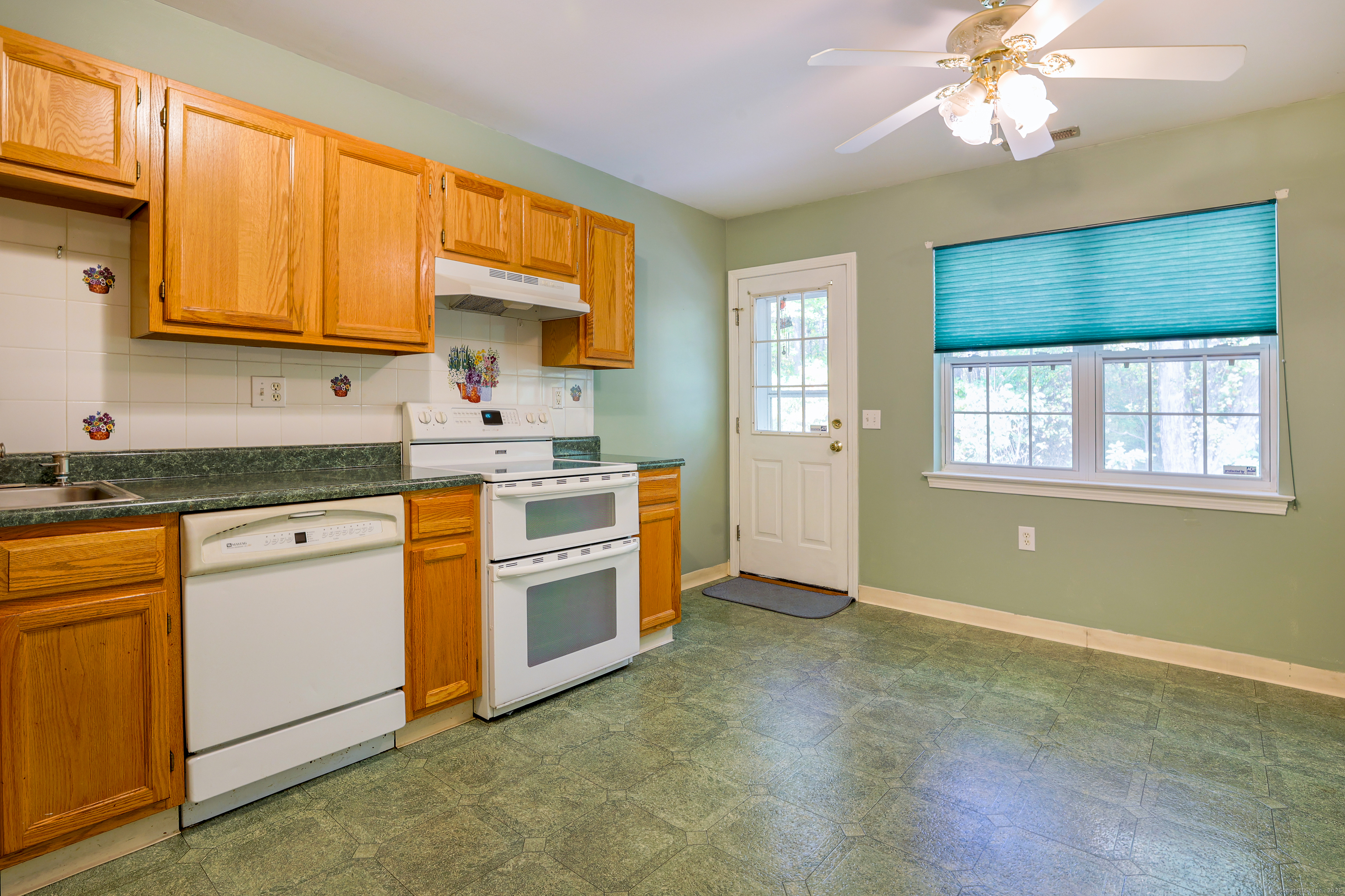 150 Forest Road, Unit 6 Milford, CT 06461 - Photo 12 of 26 a kitchen with stainless steel appliances granite countertop a stove a sink and a refrigerator