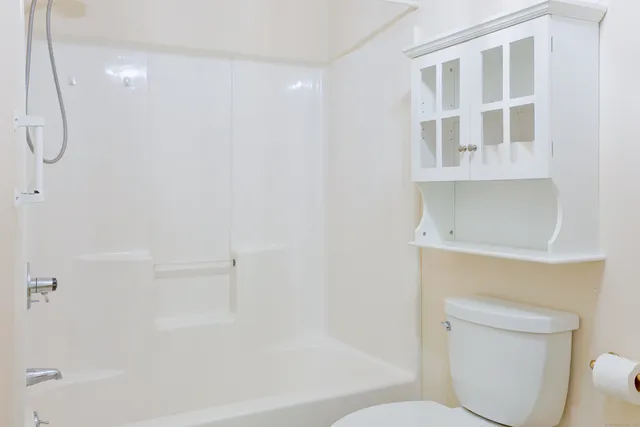 a bathroom with a toilet and a shower