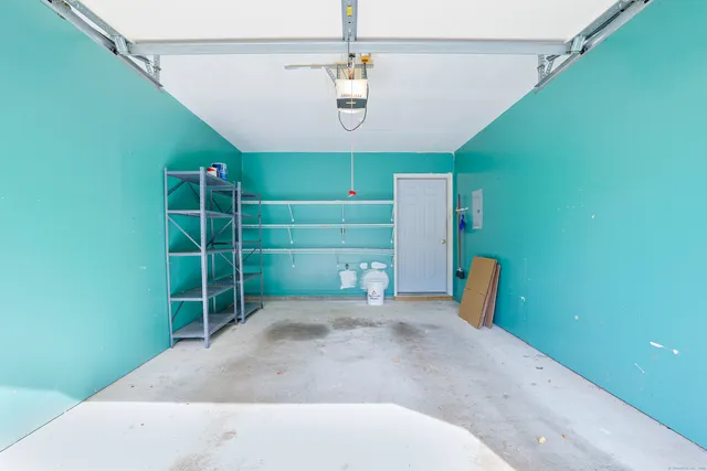 a front view of a house with garden and chairs
