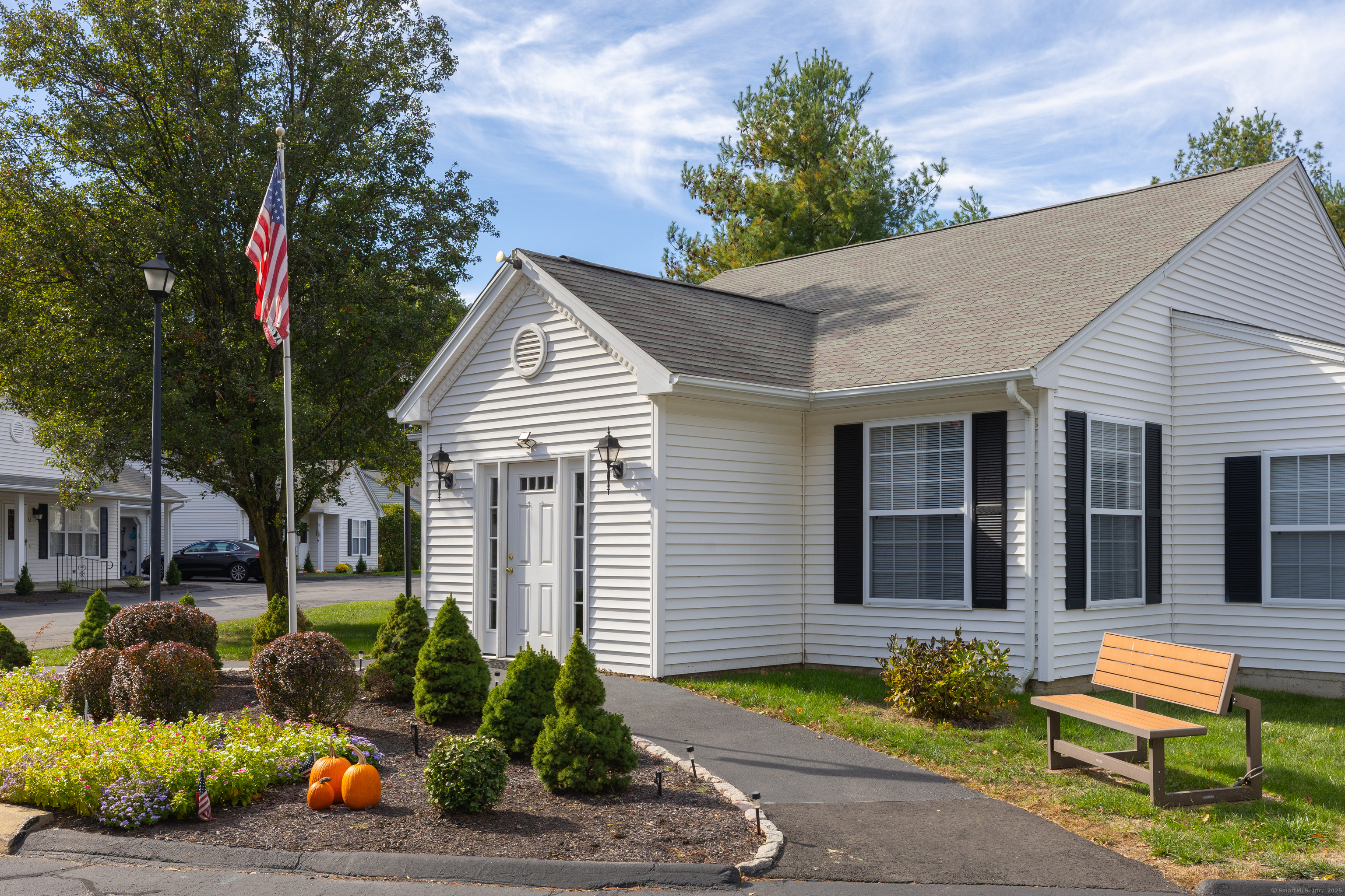150 Forest Road, Unit 6 Milford, CT 06461 - Photo 20 of 26 a front view of a house with garden and chairs