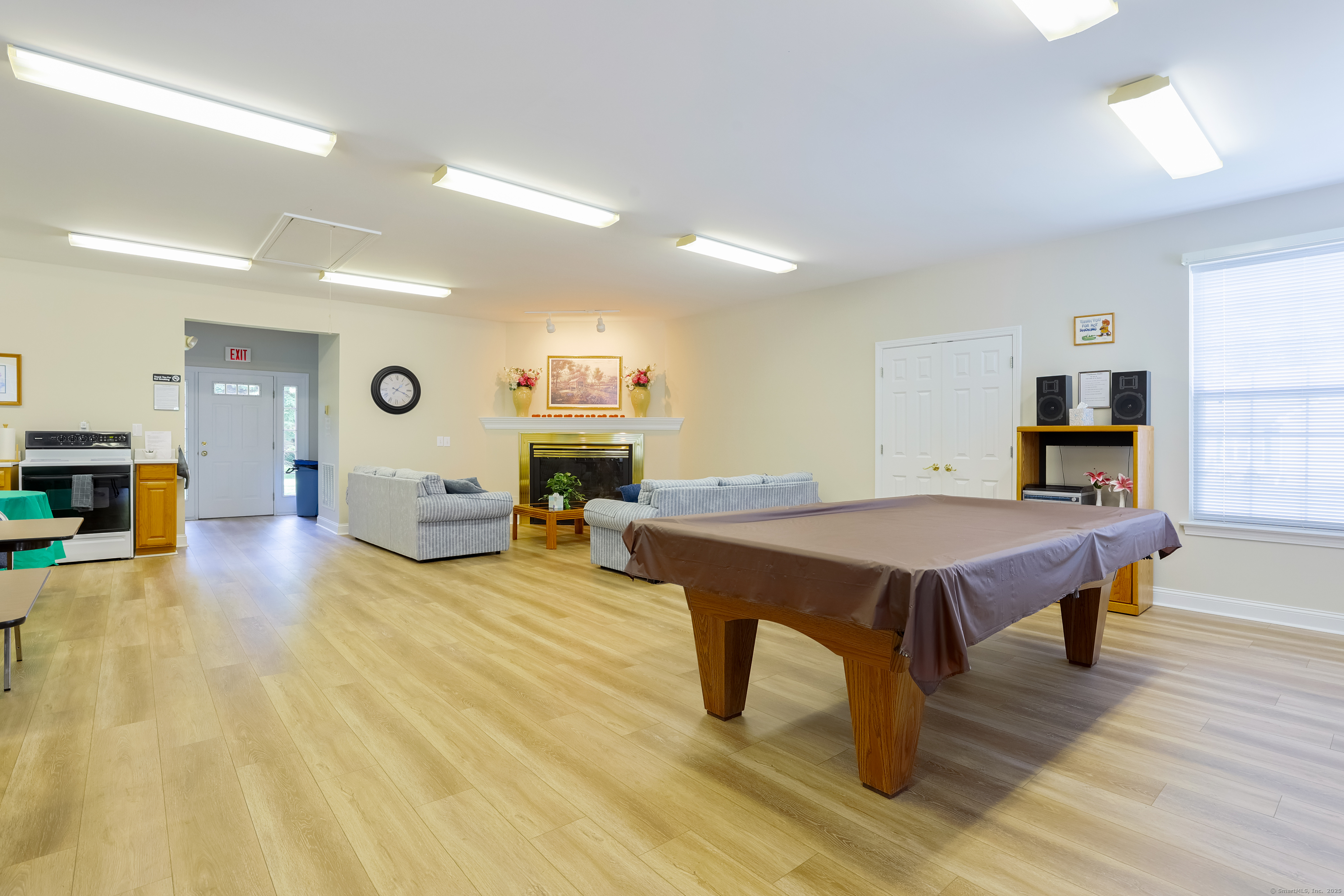 150 Forest Road, Unit 6 Milford, CT 06461 - Photo 23 of 26 a living room with furniture pool table wooden floor and windows