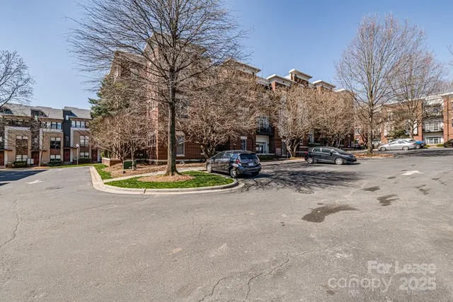 a view of a fountain with large trees