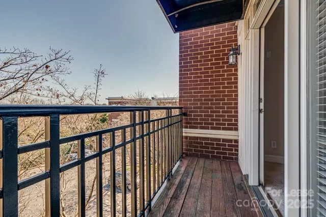 a view of a balcony with wooden floor