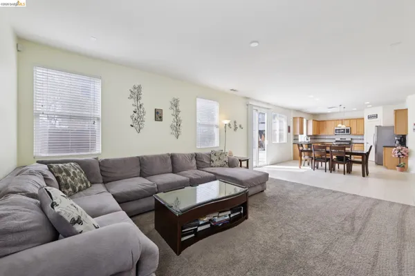 a dining area with furniture and a floor to ceiling window