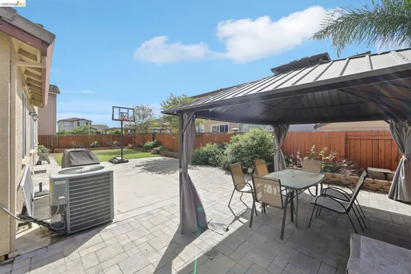 a view of a backyard with sitting area