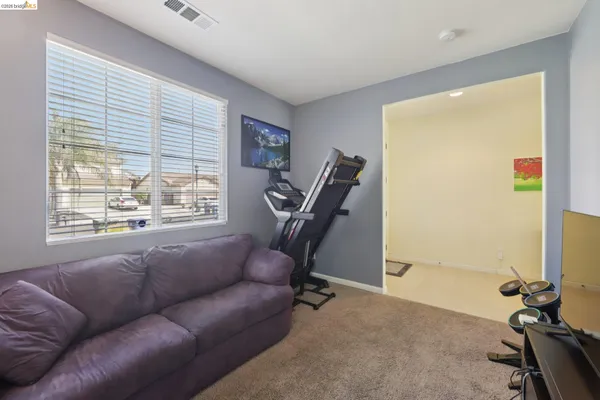 a living room with furniture a air conditioner and a large window