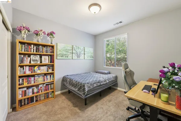 a bedroom with a bed and a bookshelf