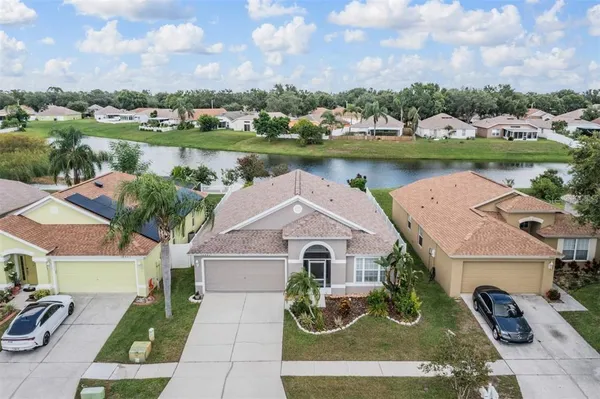 an aerial view of a house with garden space and lake view